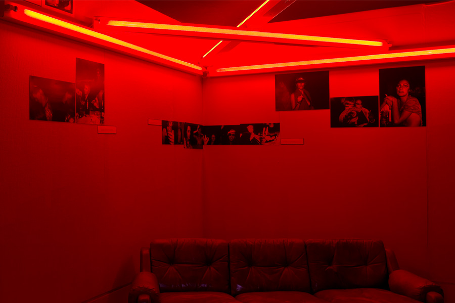 Backroom with Dan Flavin Red Neon Triangle Sculpture 